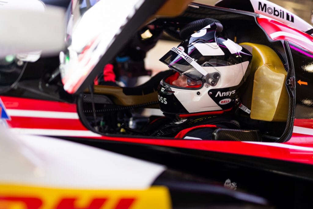 Andre Lotterer sitting in his Porsche 963 with his helmet on.